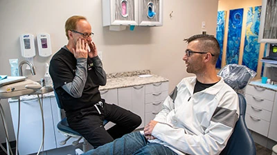 Dr. Burt explaining restorative dentistry services to a patient